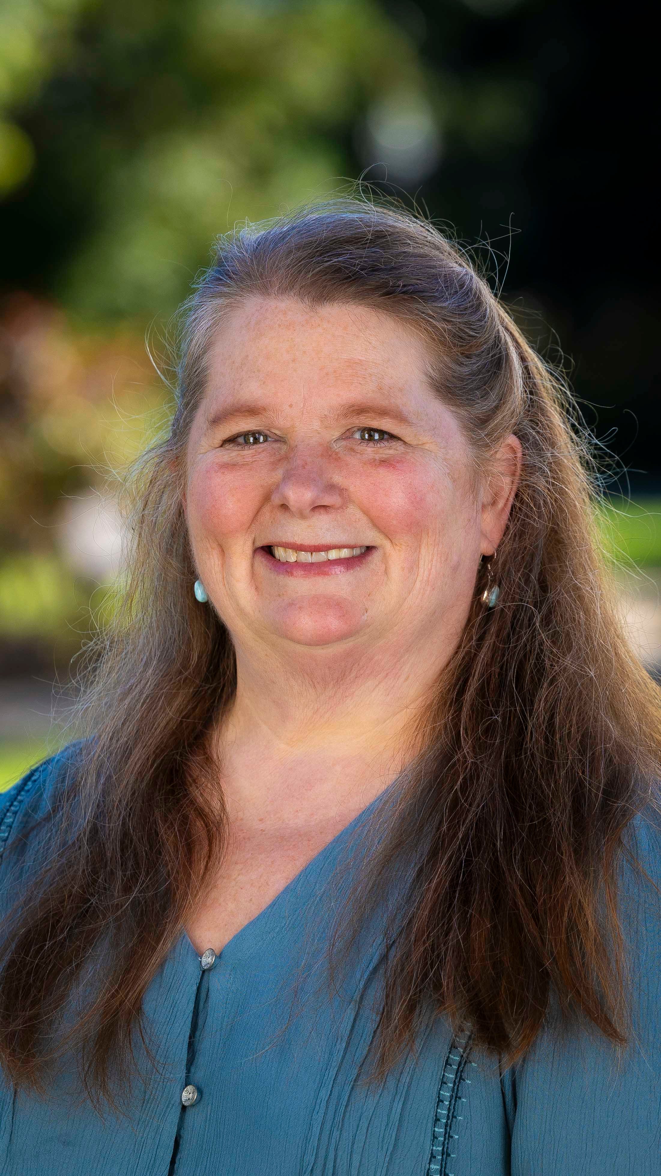 a woman with long hair smiling