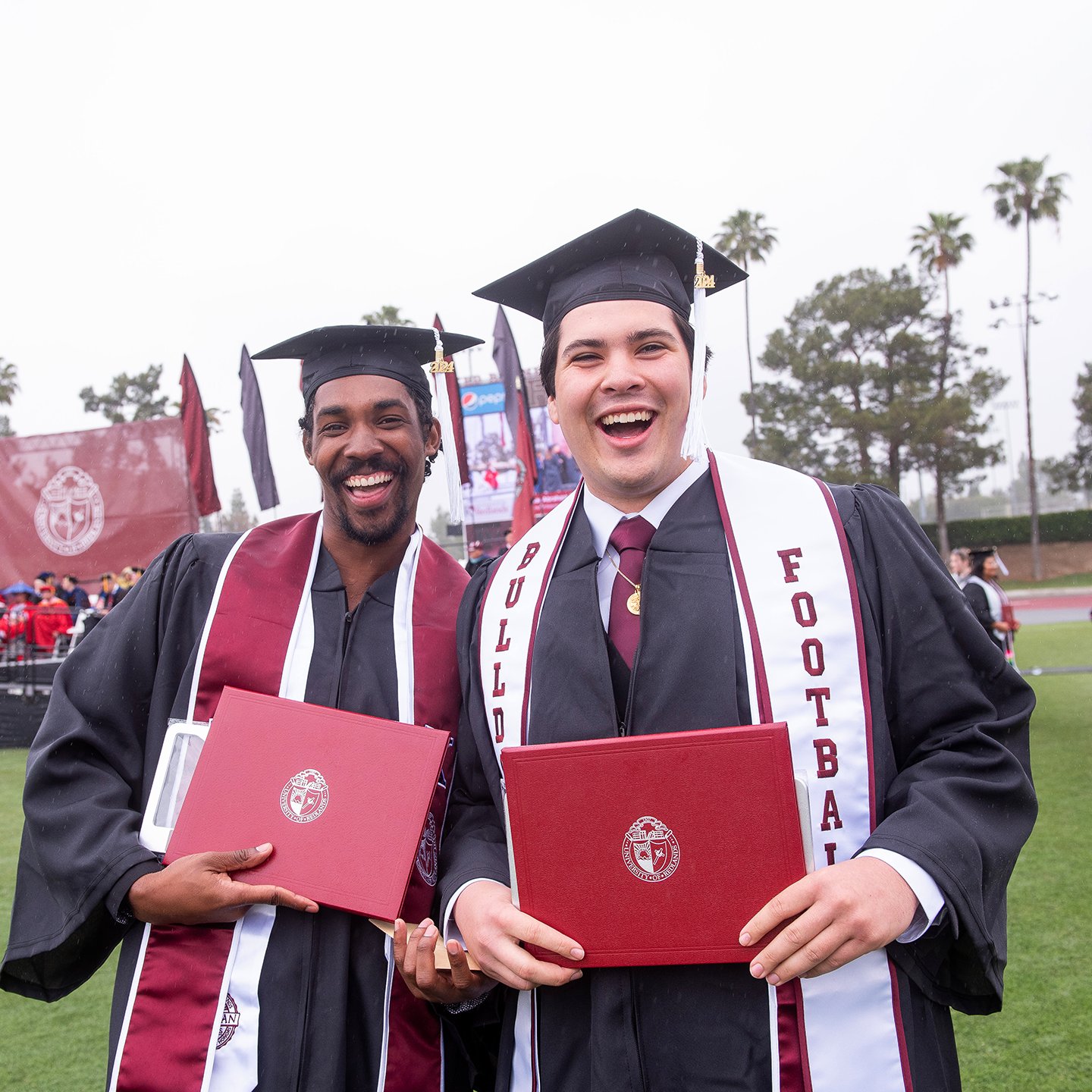 a group of men in graduation gowns and caps