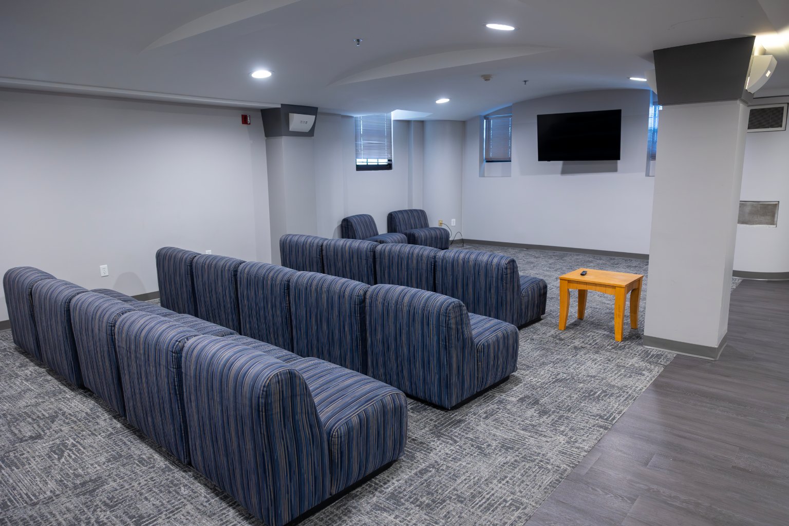 a room with blue couches and a table