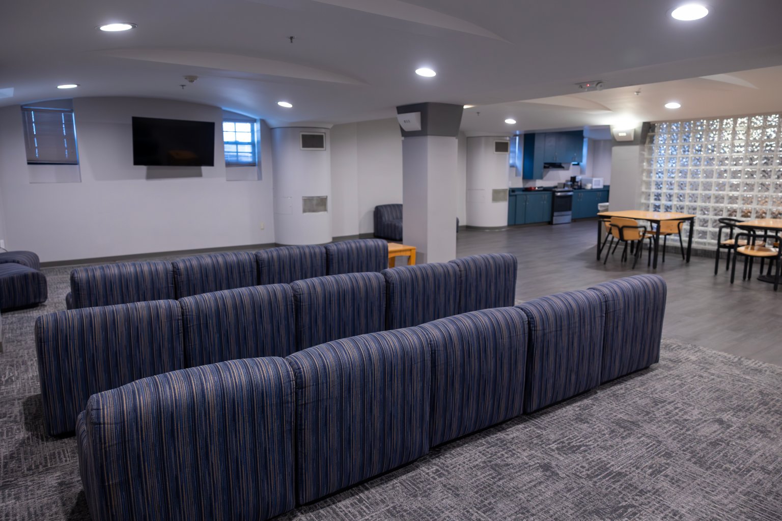 a room with blue chairs and a table