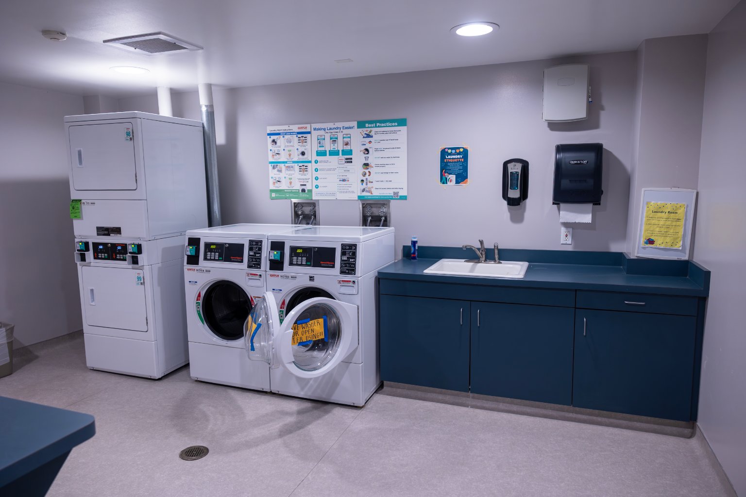 a laundry room with washers and dryers
