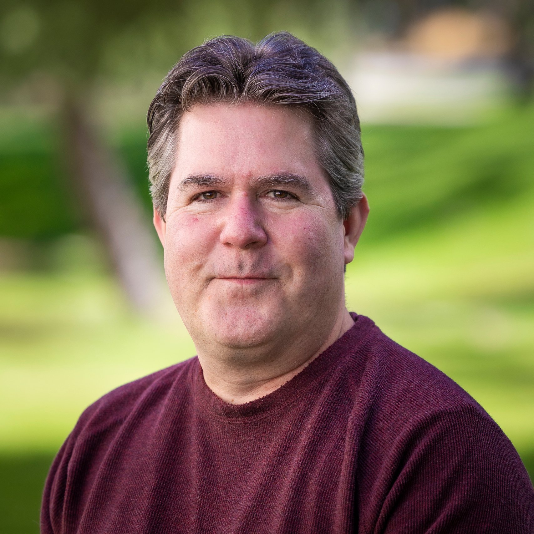 a man in a maroon shirt