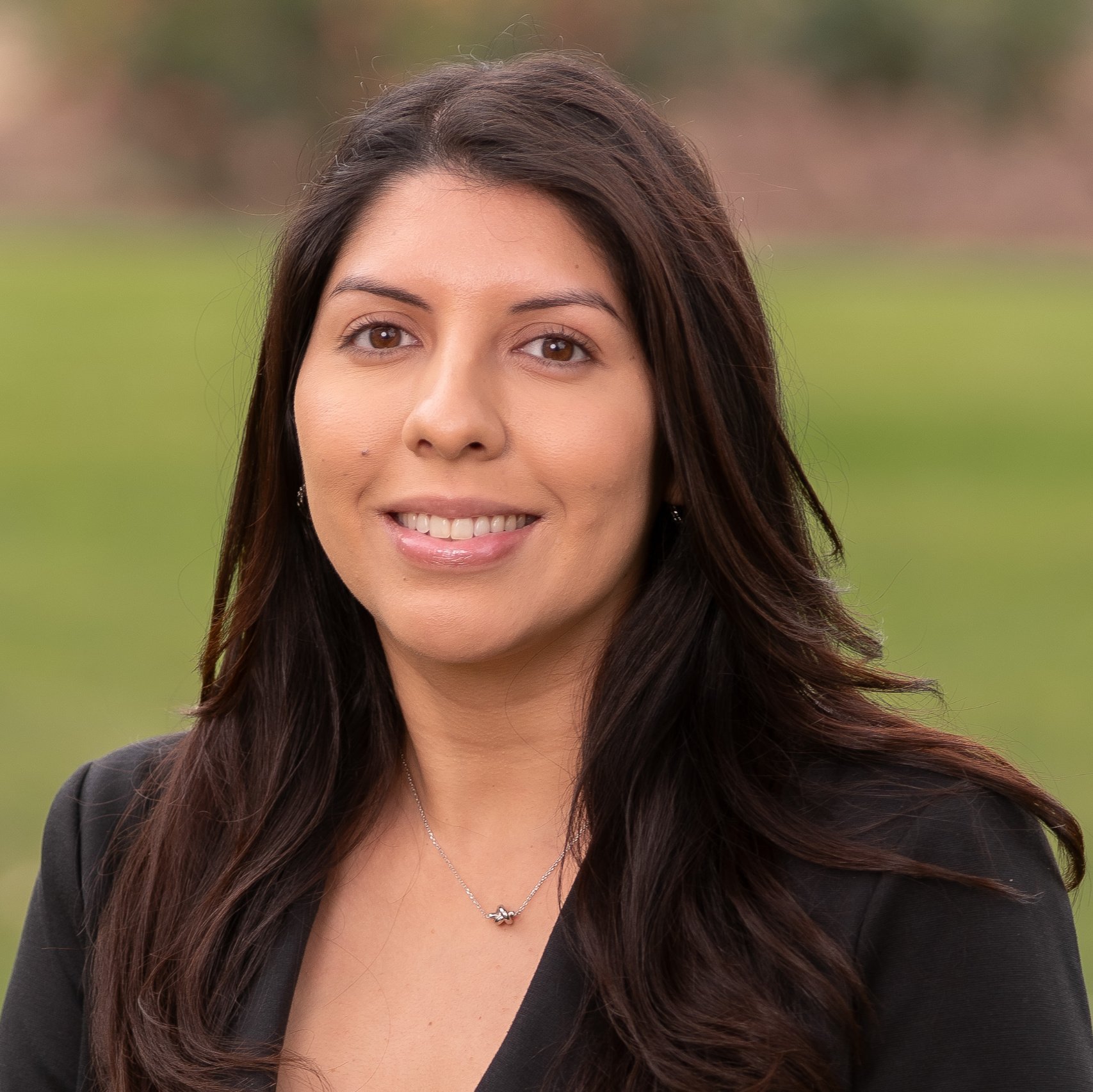 a woman with long brown hair smiling