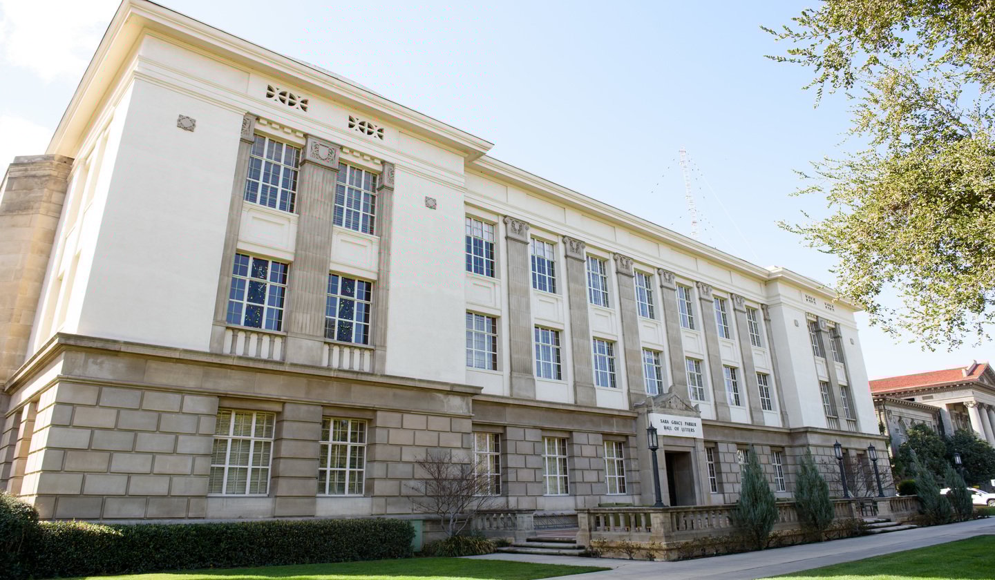 a large building with a door and a sign
