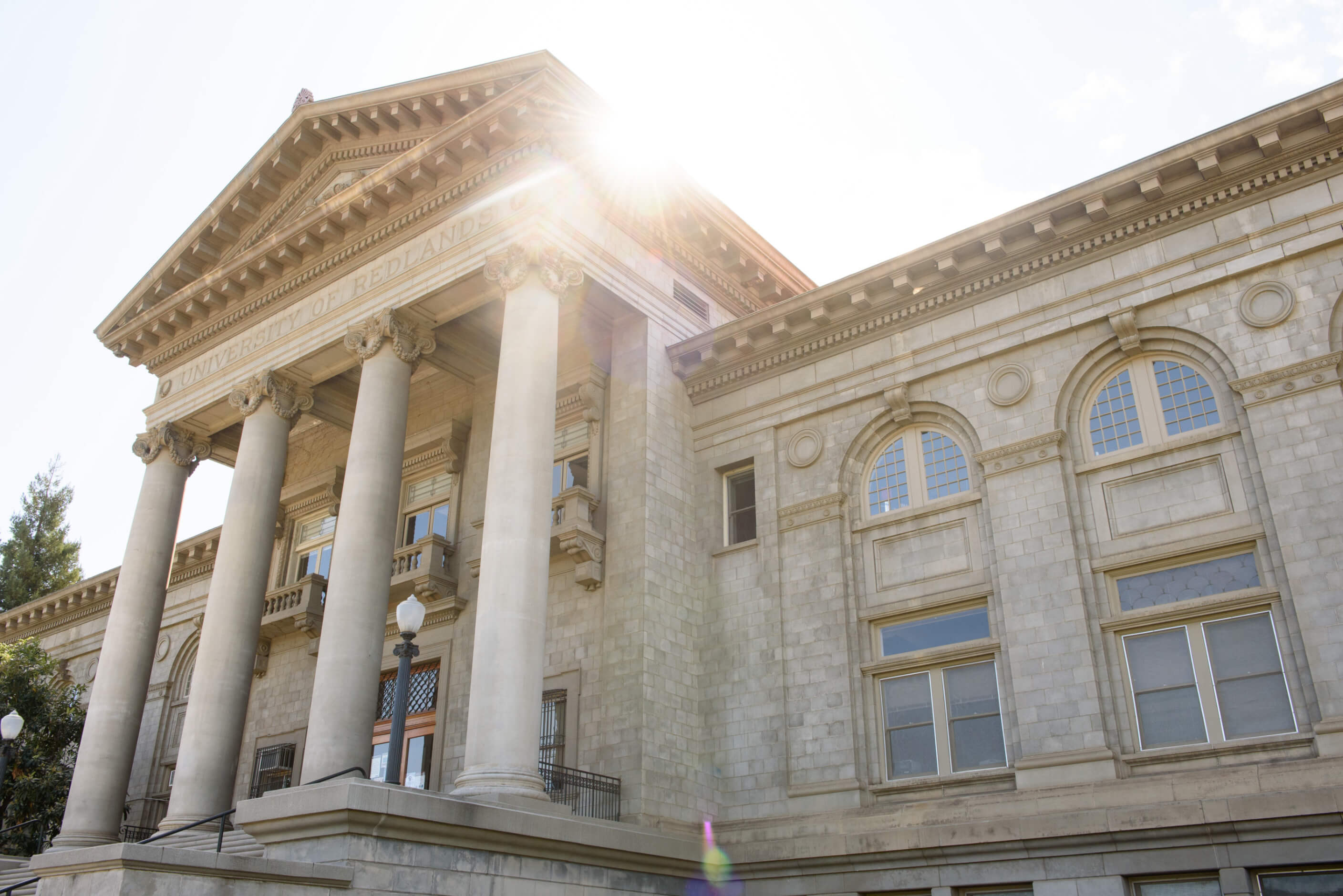 a building with columns and a light pole