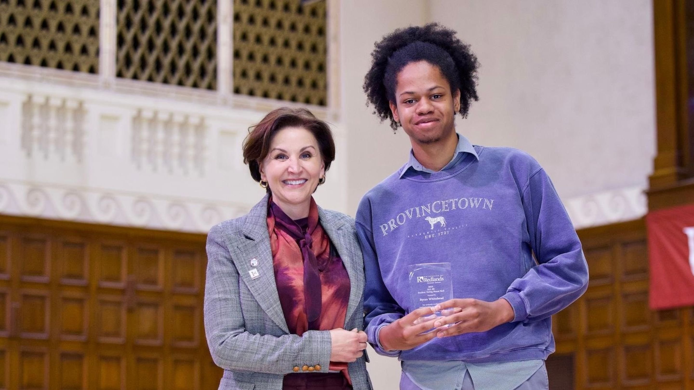 a man and woman holding a trophy