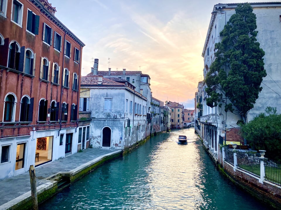 a water canal with buildings and a boat