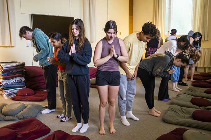 a group of people standing in prayer