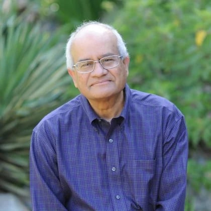 a man wearing glasses and a blue shirt