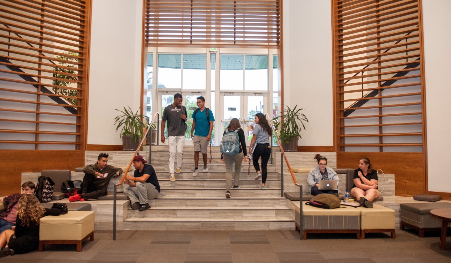 a group of people walking up stairs in a building