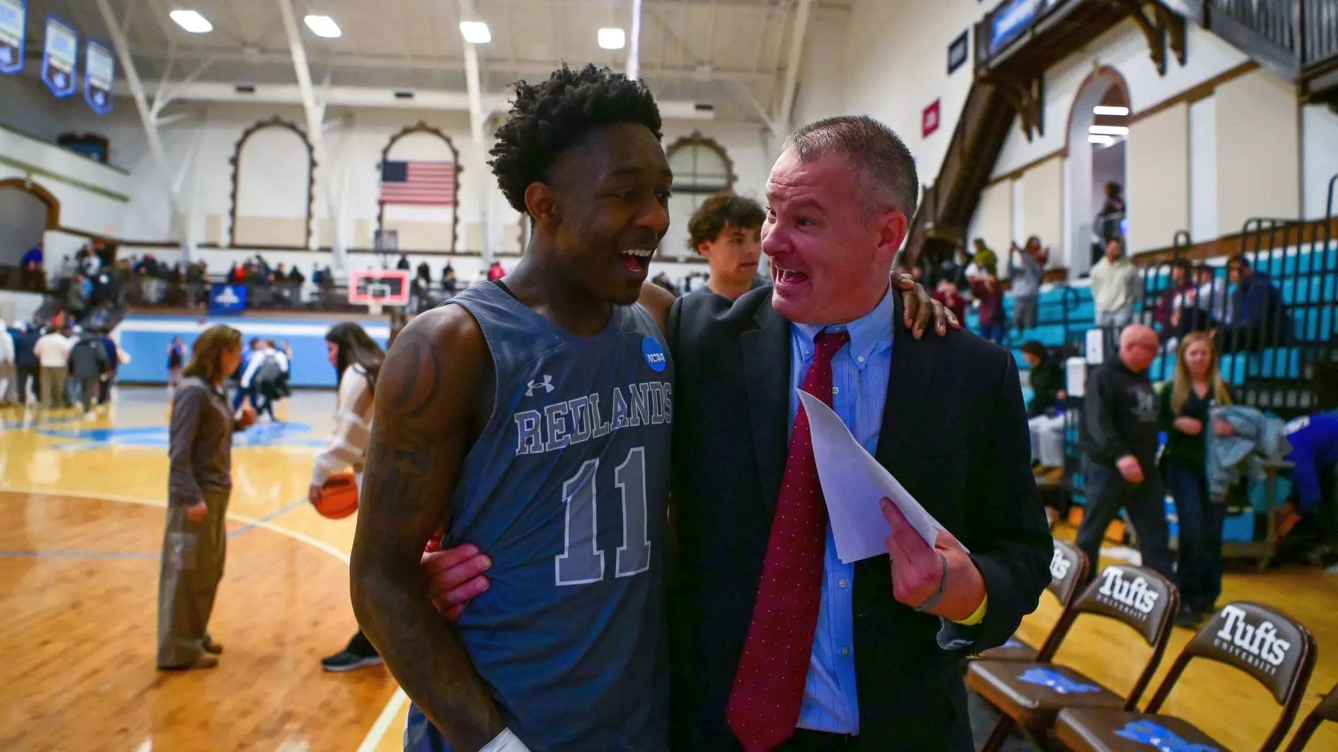 a man in a suit and a basketball player in a gym