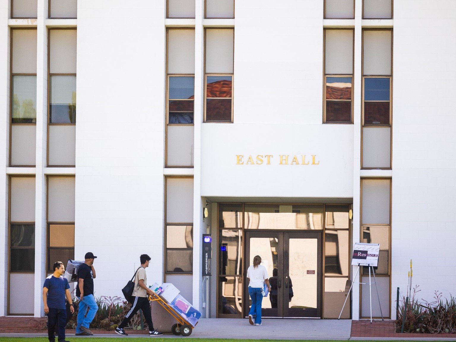 people walking in front of a building