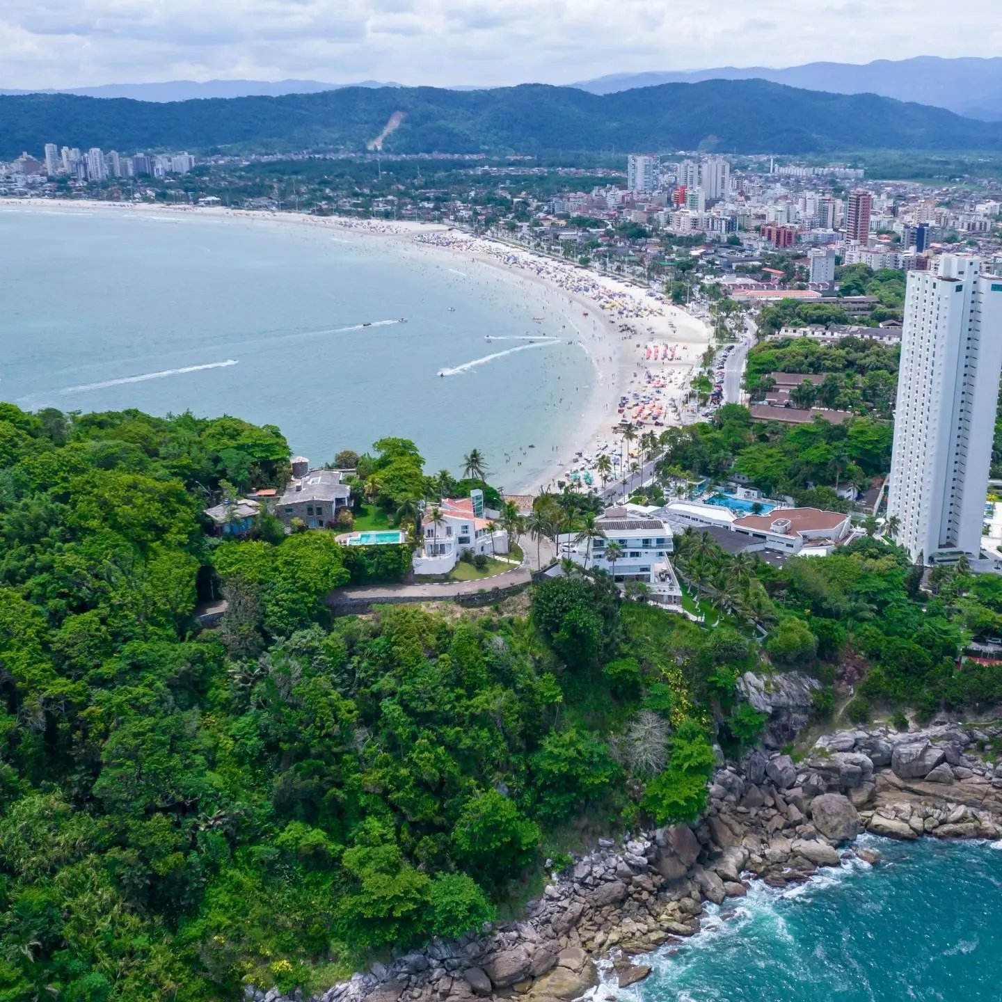 a beach with buildings and trees