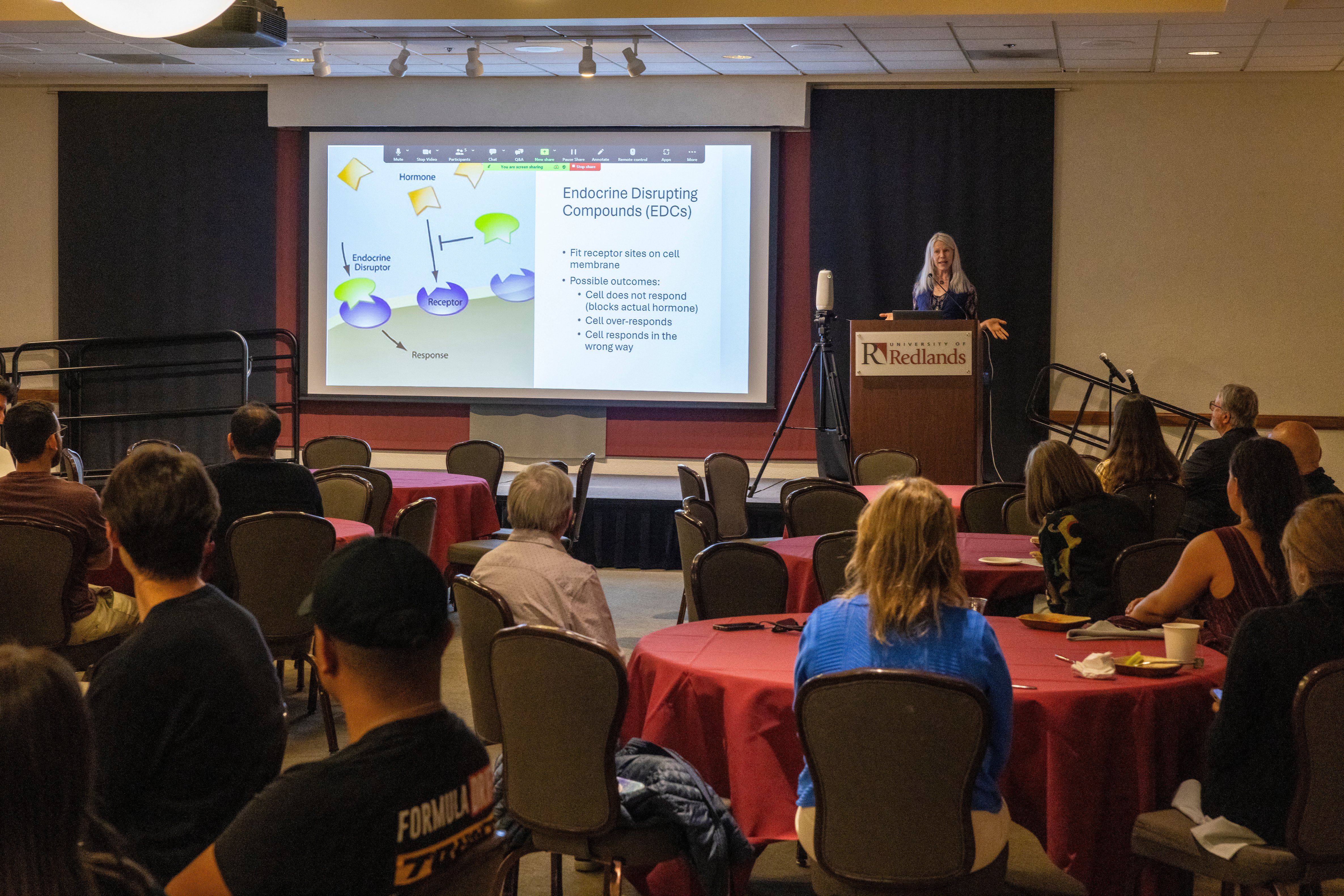 a woman standing in front of a screen