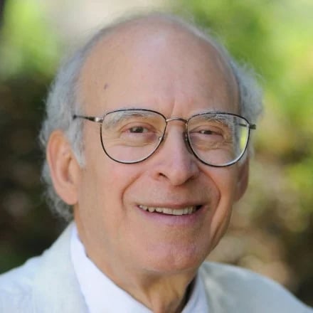 a man wearing glasses smiling