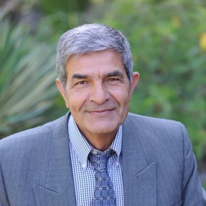 a man in a suit smiling