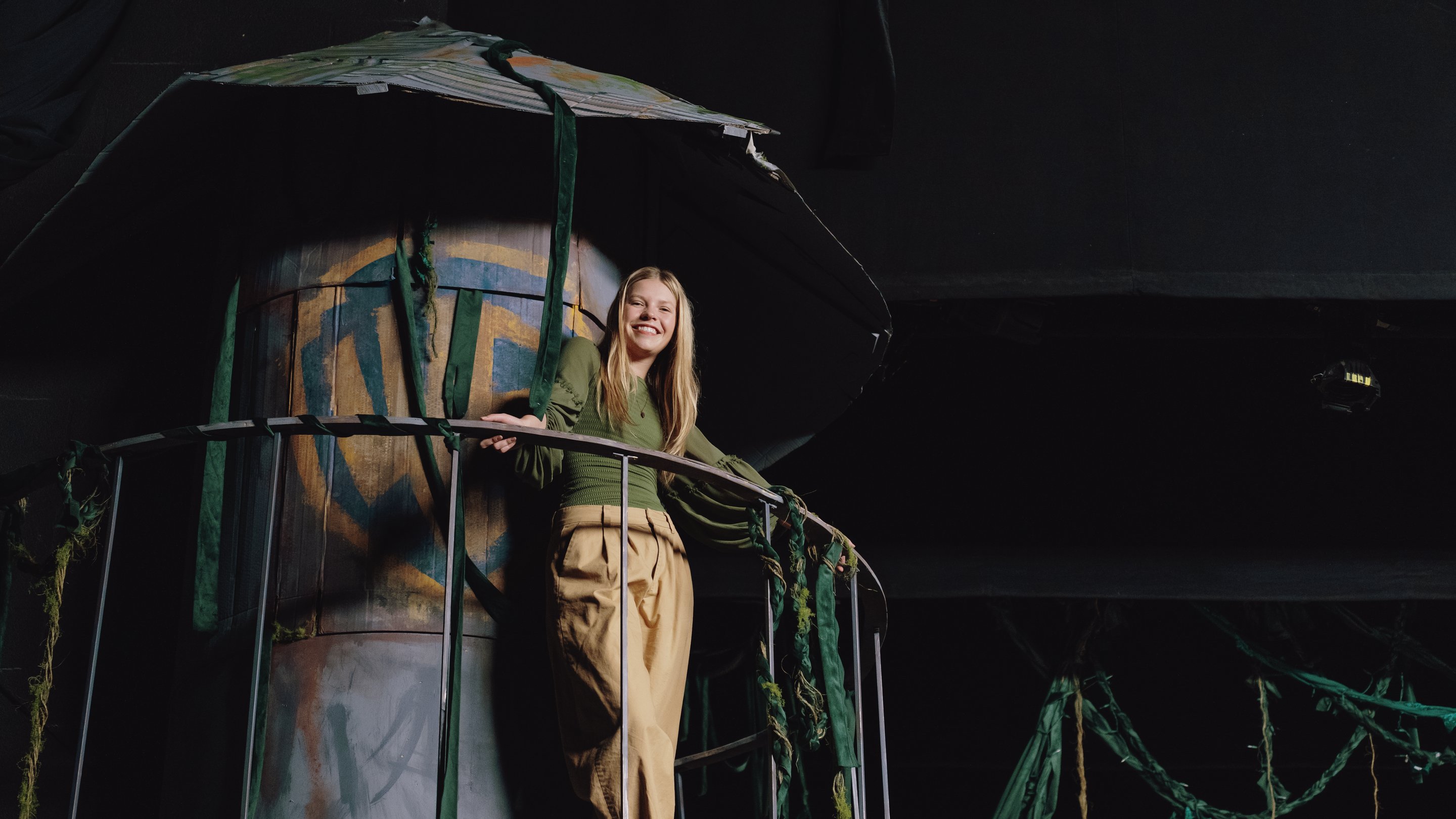 a woman leaning on a railing