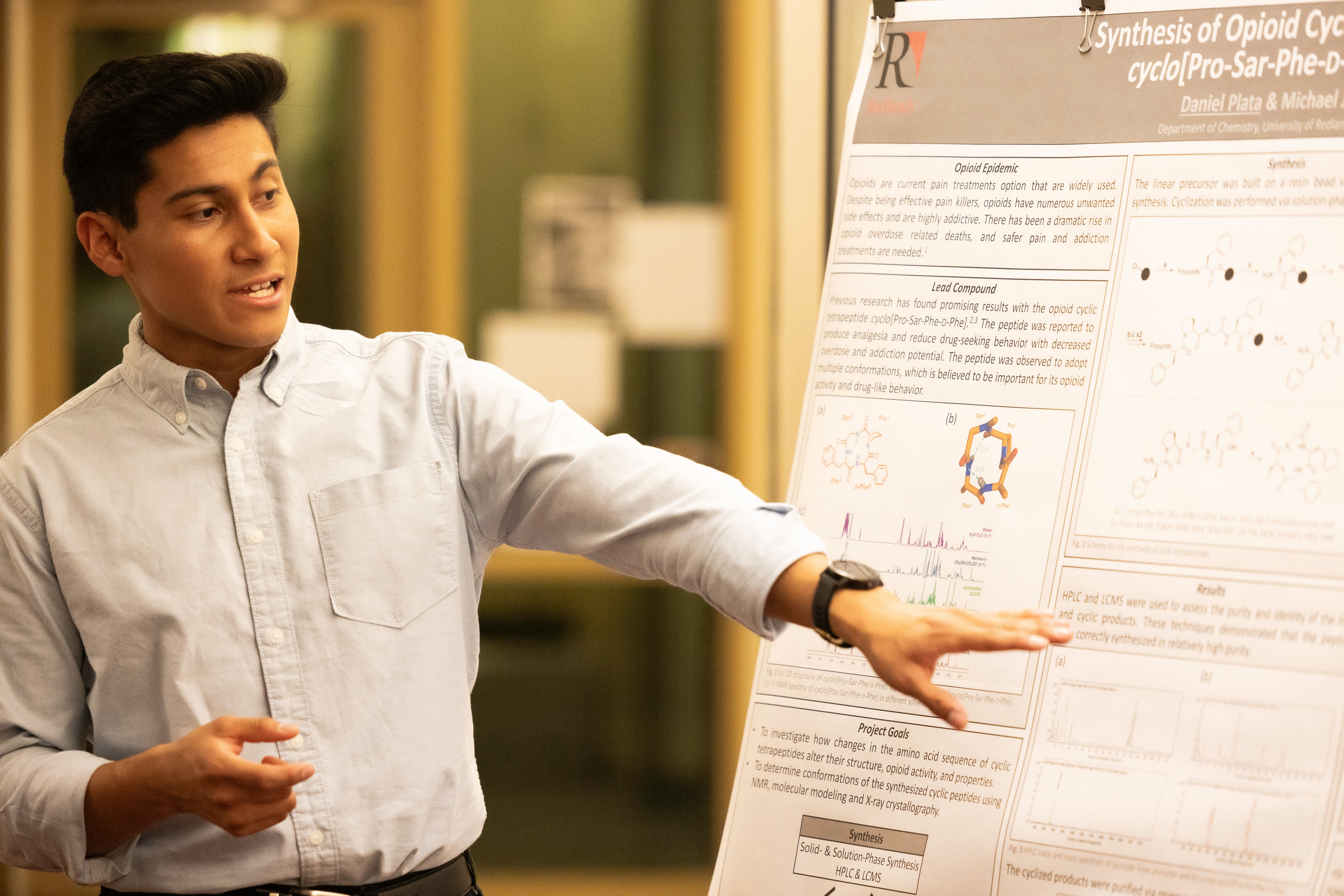 a man pointing at a white board