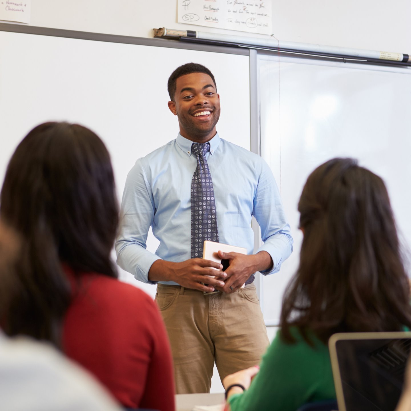 a man standing in front of a whiteboard
