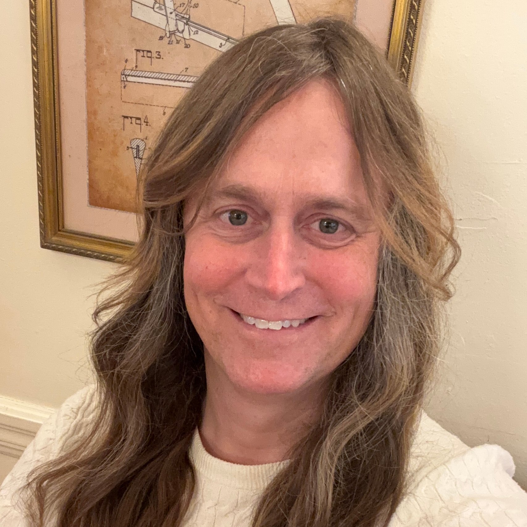 a woman with long hair smiling