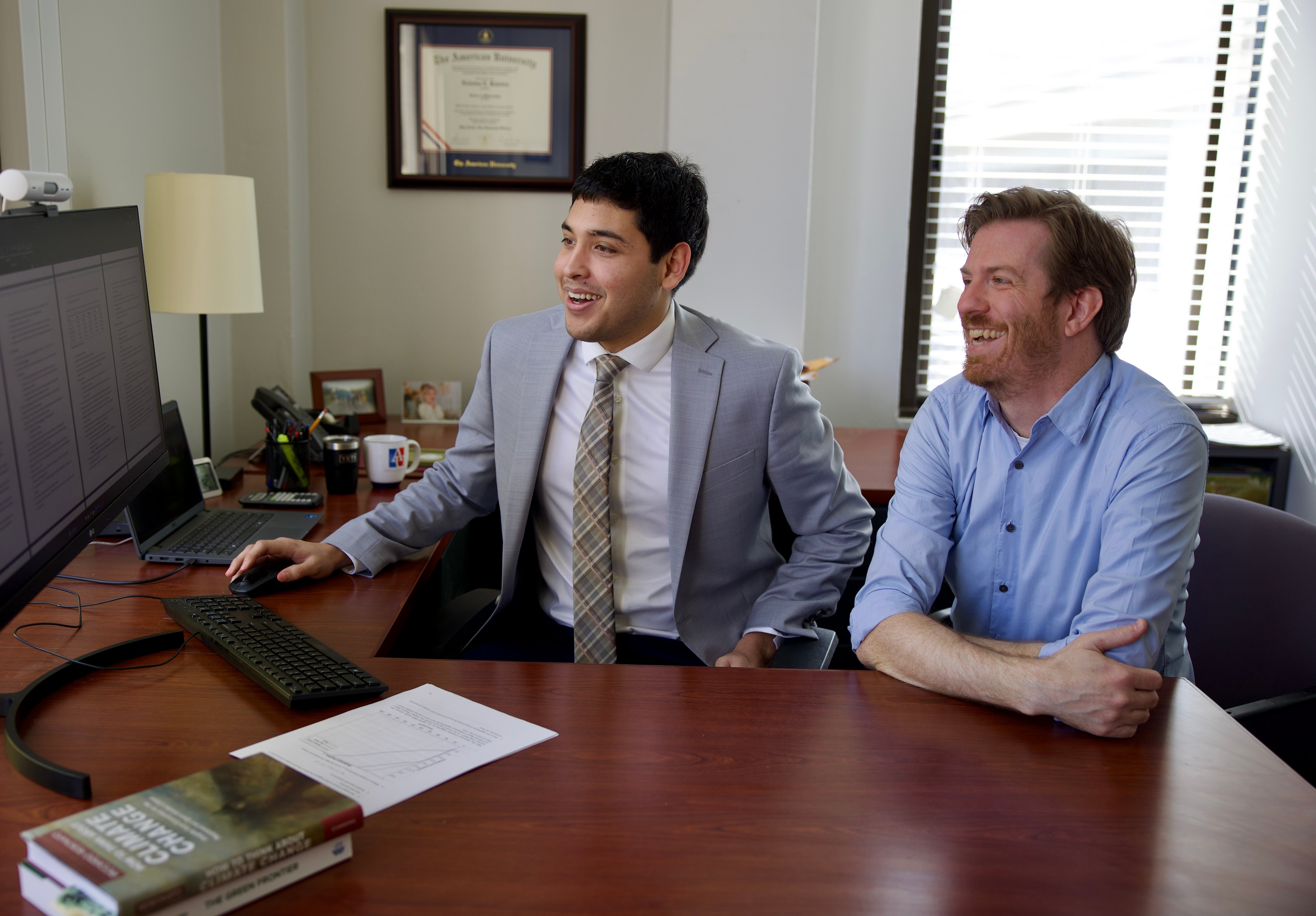 a group of men sitting at a desk