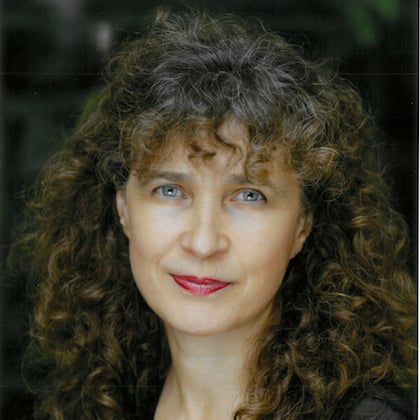 a woman with curly hair and red lipstick