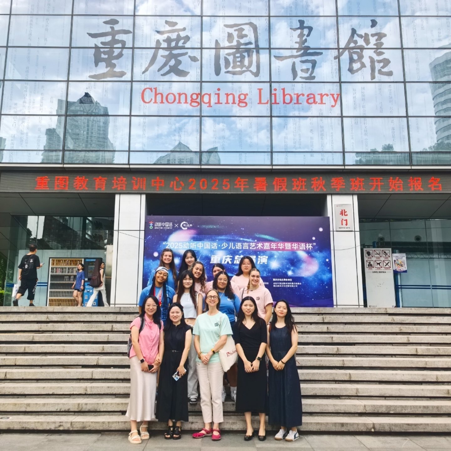 a group of people posing for a photo in front of a building