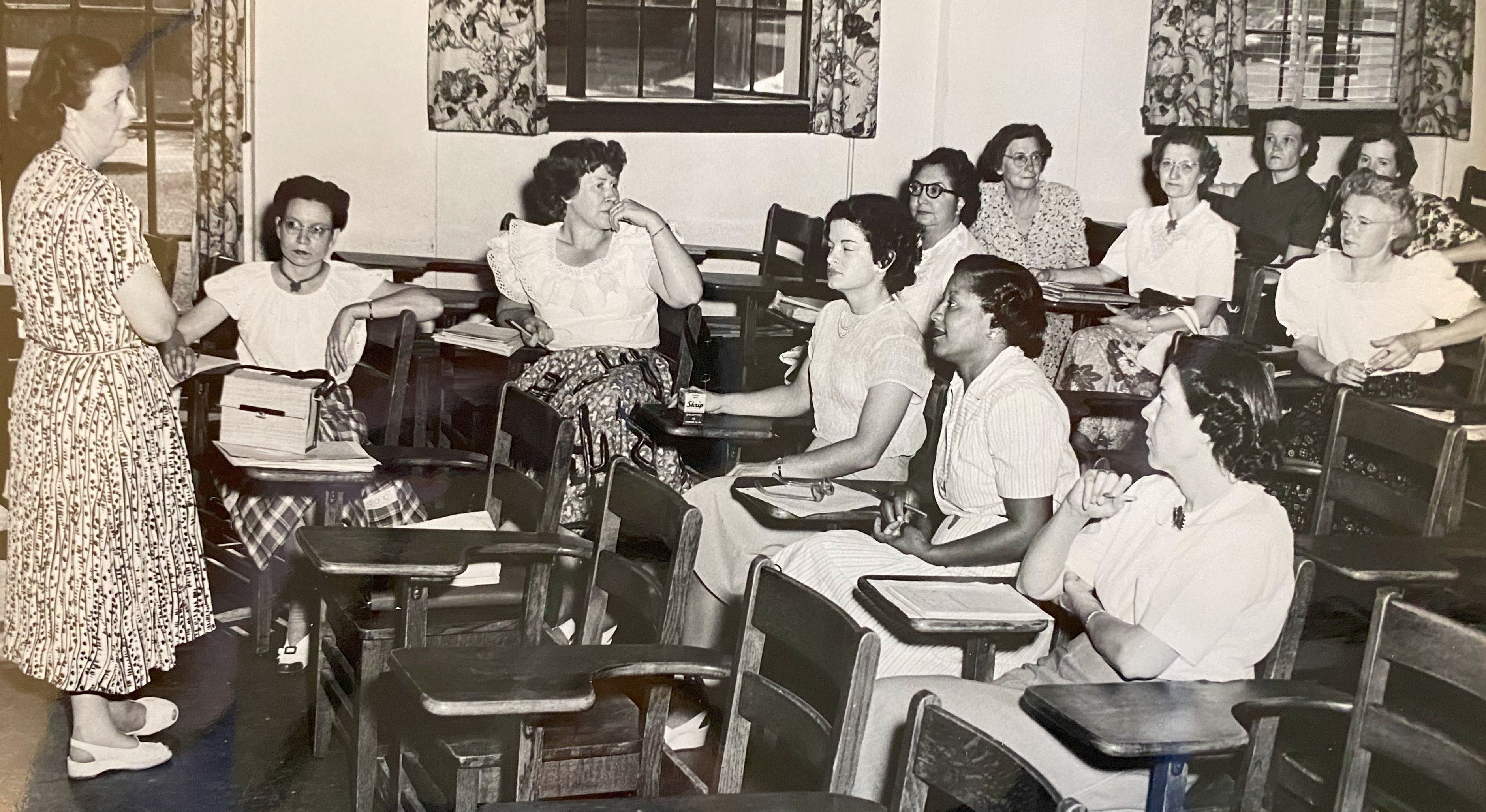 a group of people sitting in a classroom