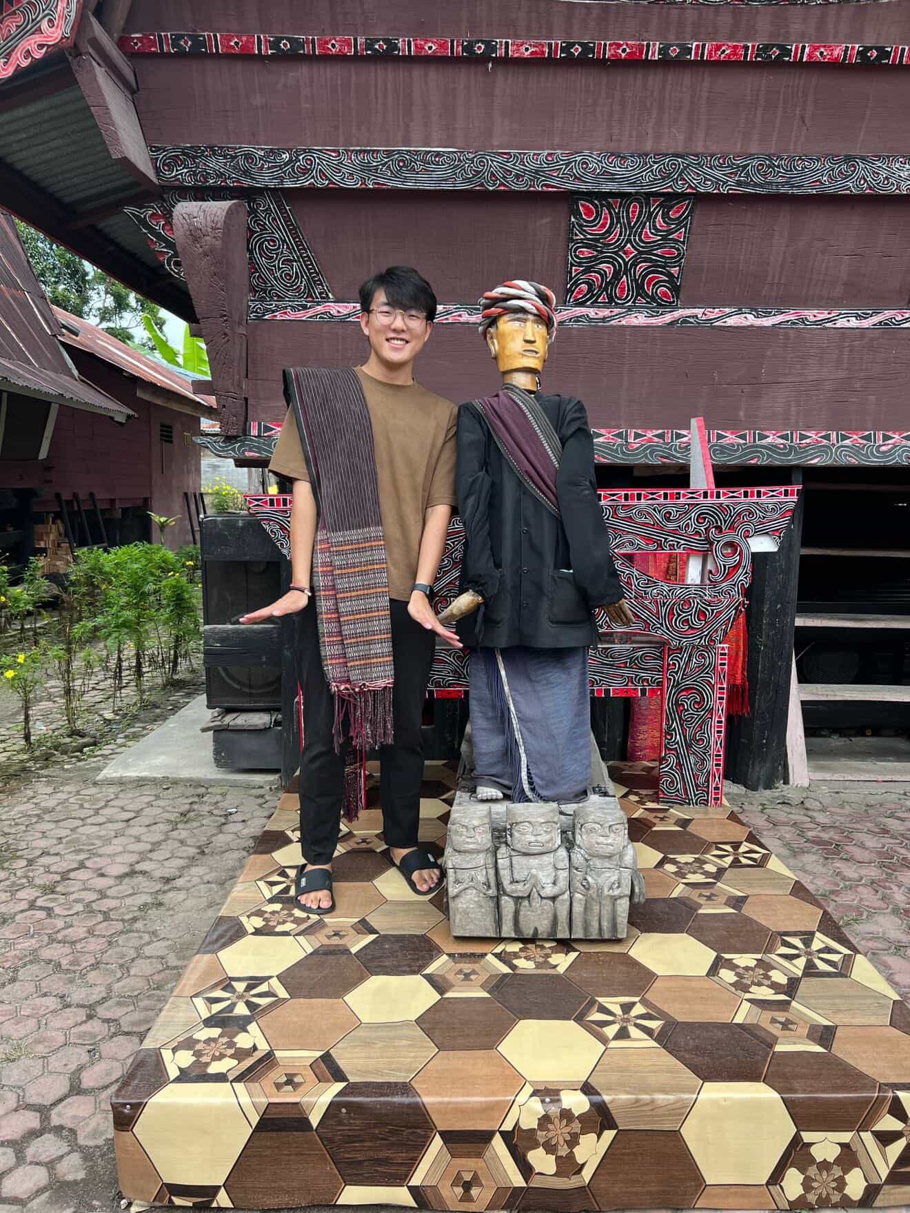 a man standing next to a statue