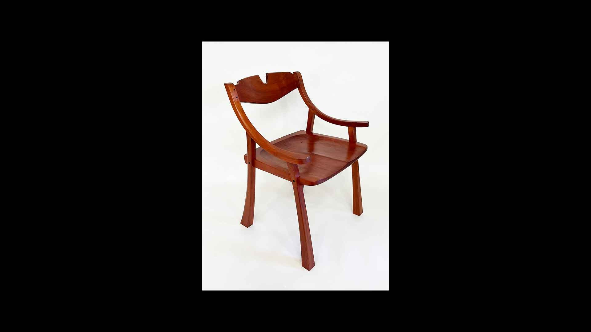 a wooden chair with a broken arm