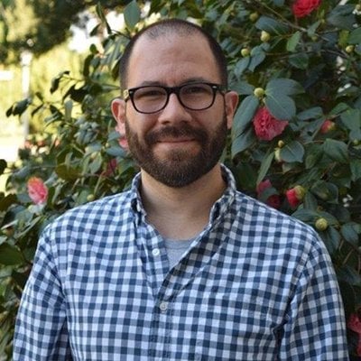 a man with a beard and glasses