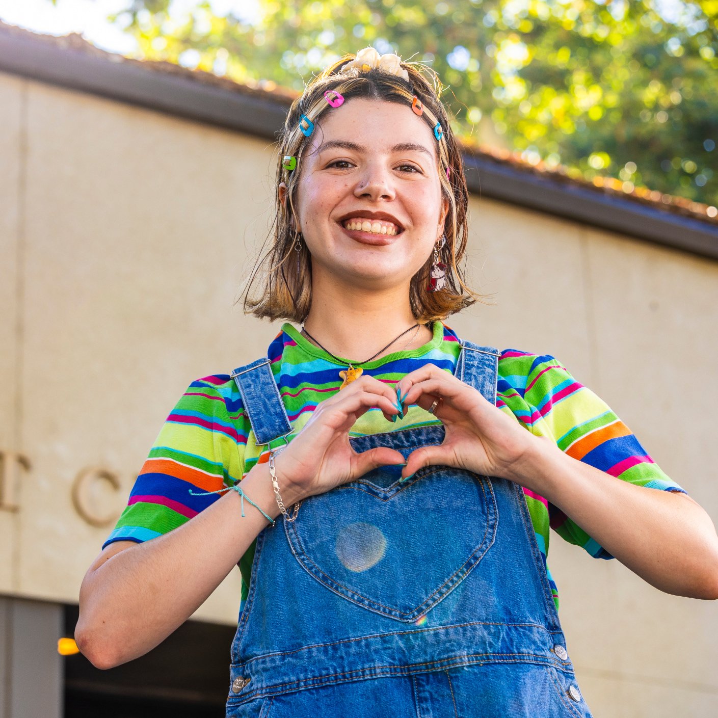 a girl making a heart with her hands