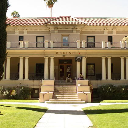 a building with columns and a lawn