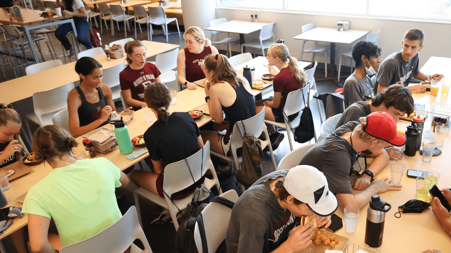 a group of people sitting at tables eating