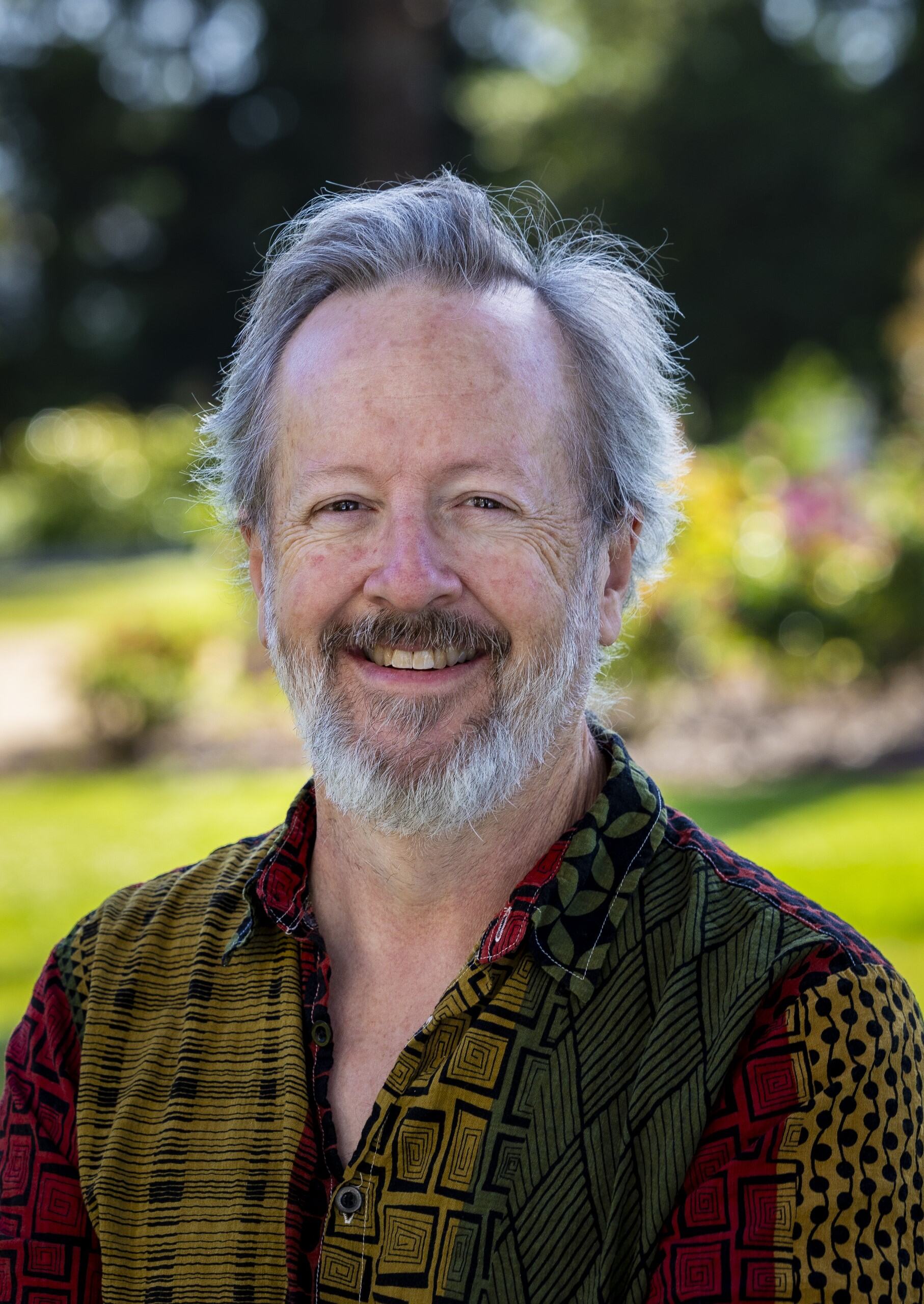 a man with a beard smiling