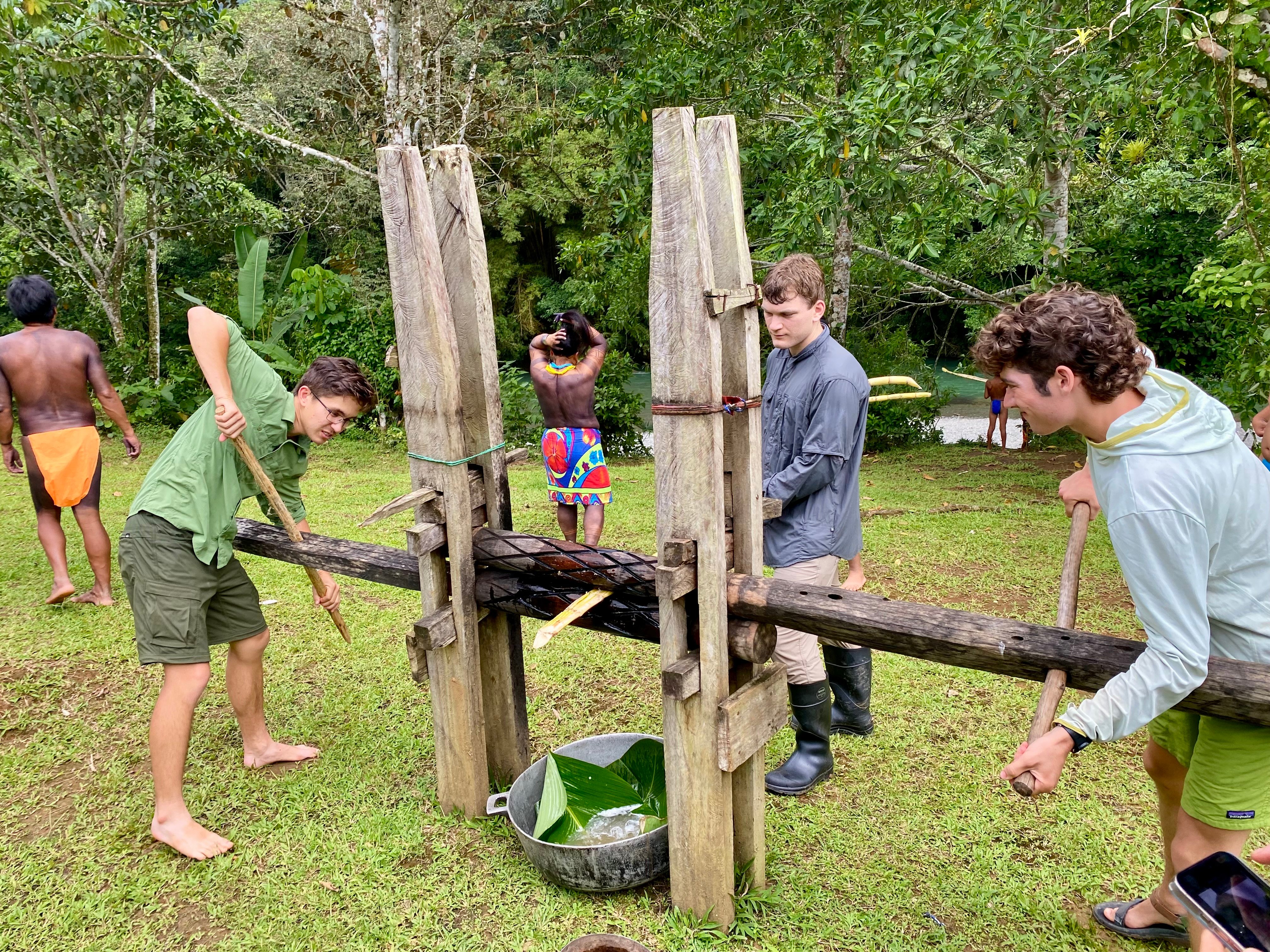a group of boys working on a wooden structure