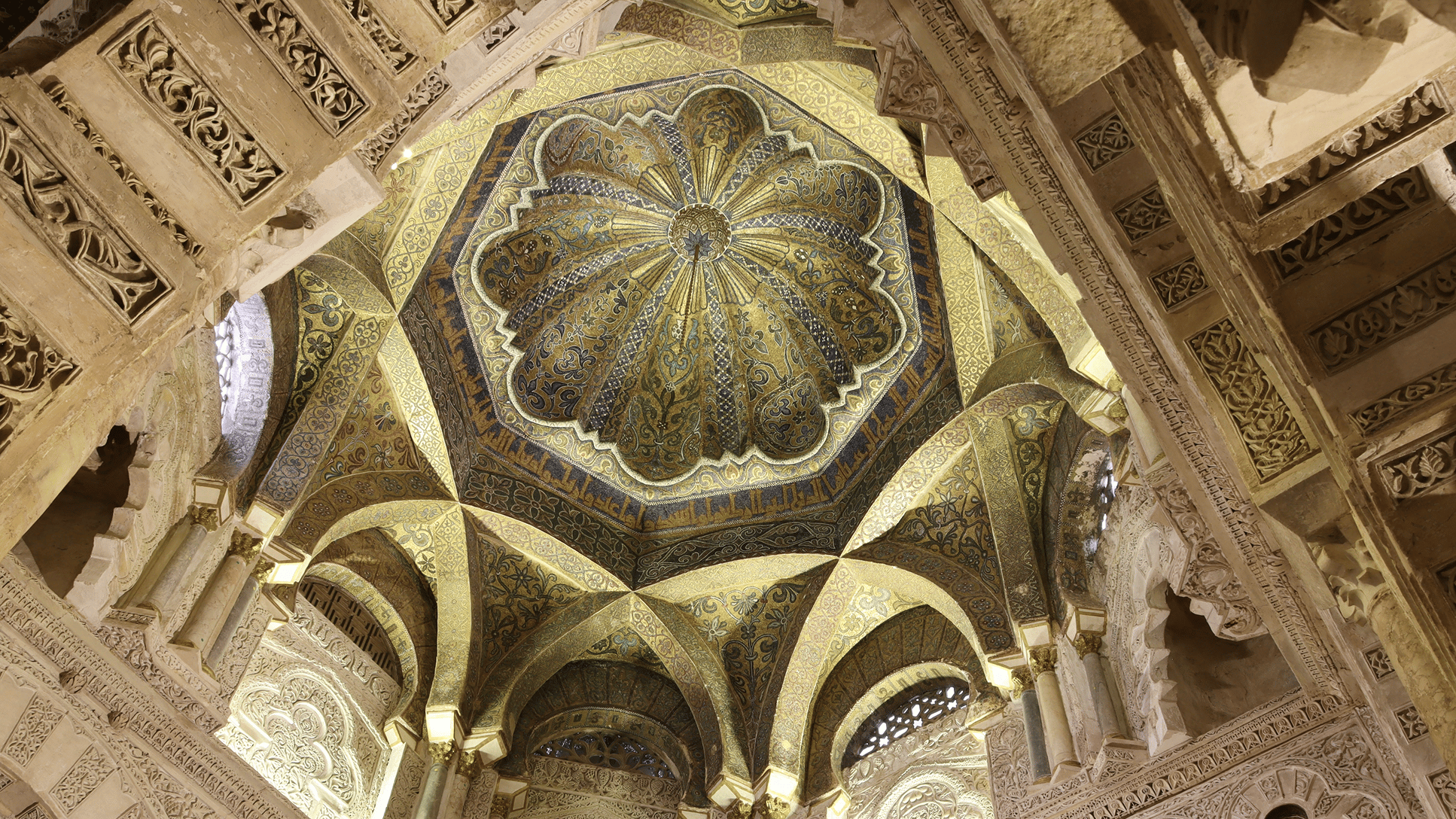 a ornate ceiling with many arches and a flower design