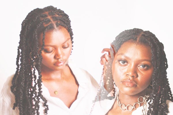 a woman with braids and necklaces