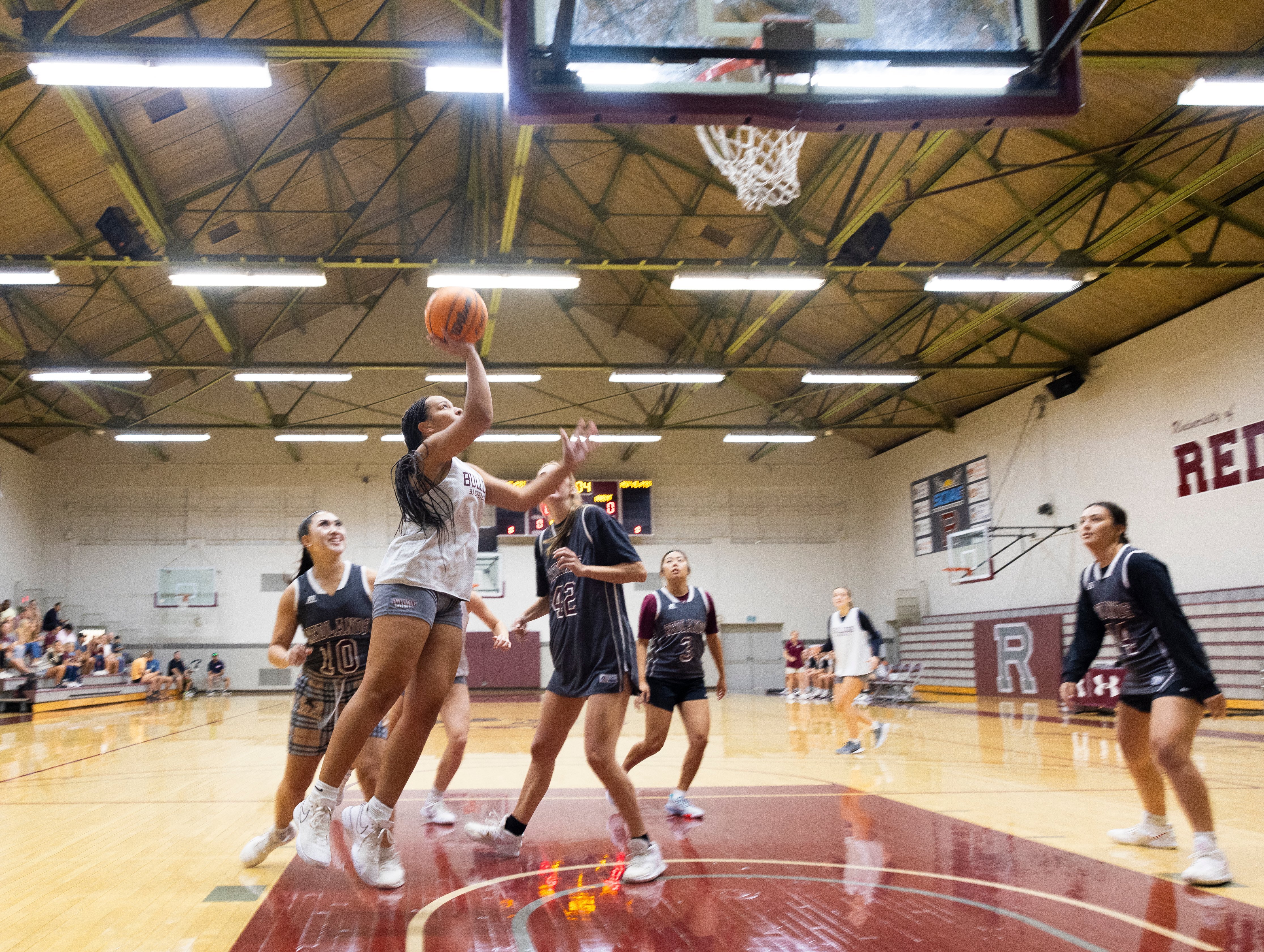 a group of people playing basketball with Lone Star Flight Museum in the background