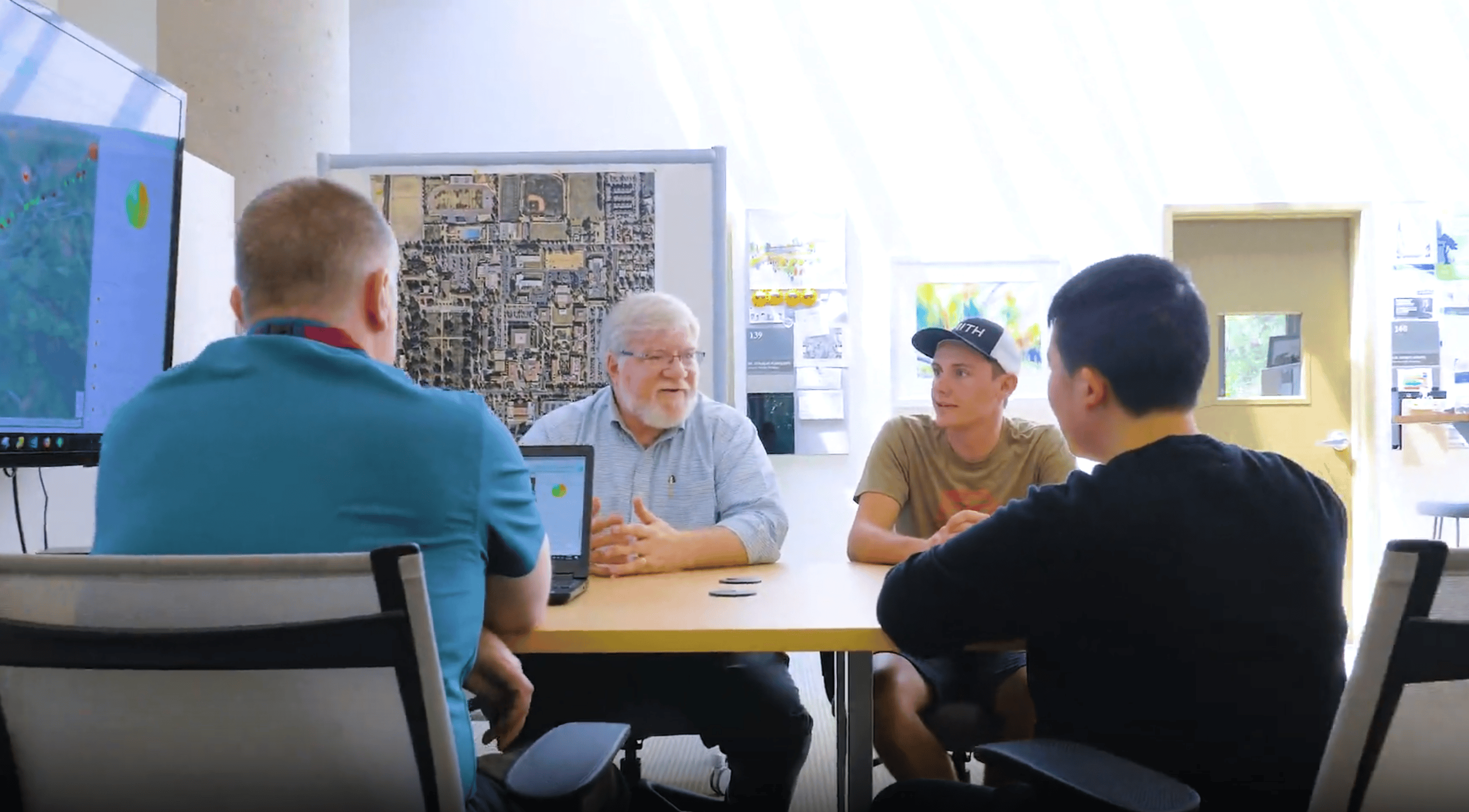 a group of men sitting around a table