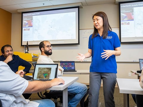 a woman standing in front of a group of people