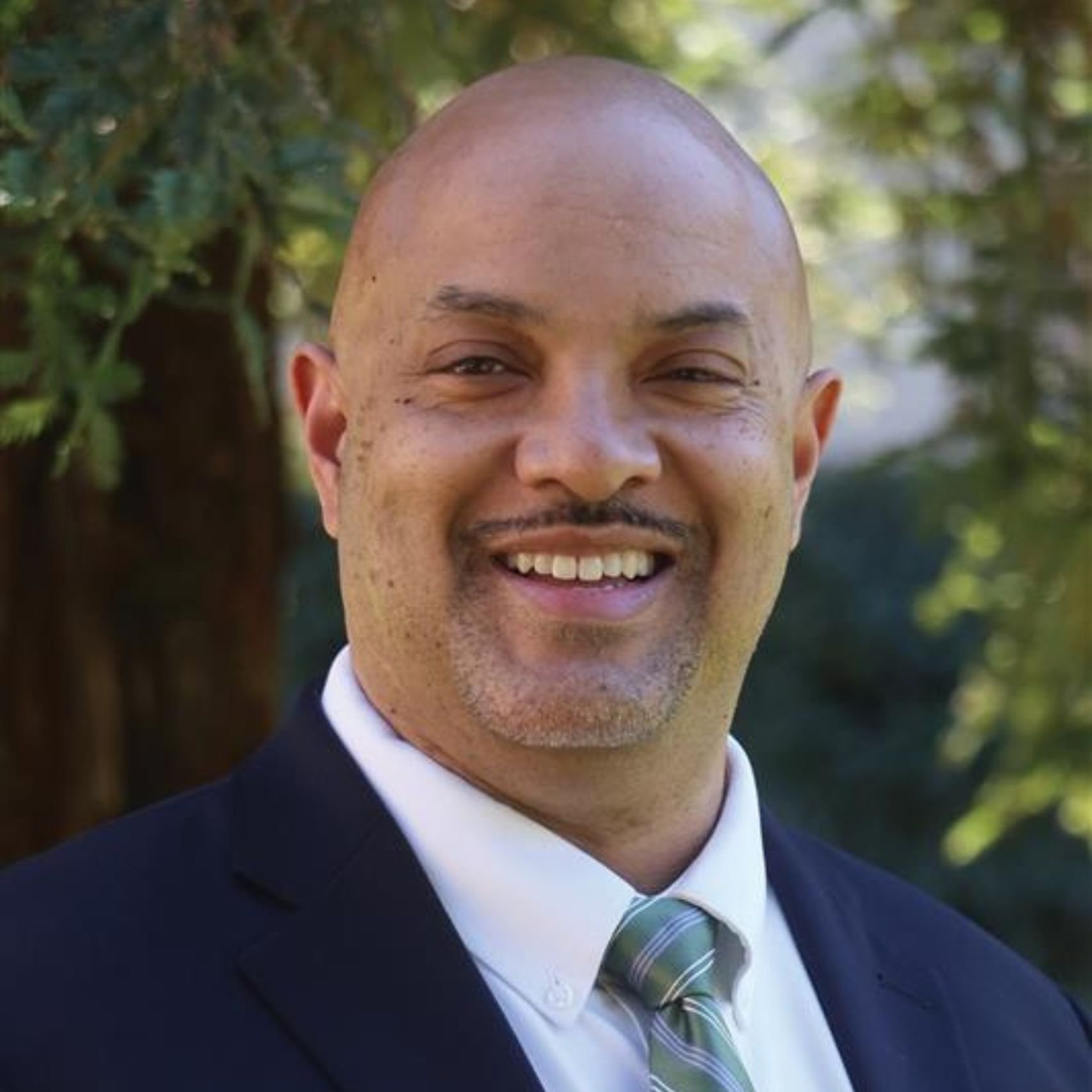 a man in a suit smiling