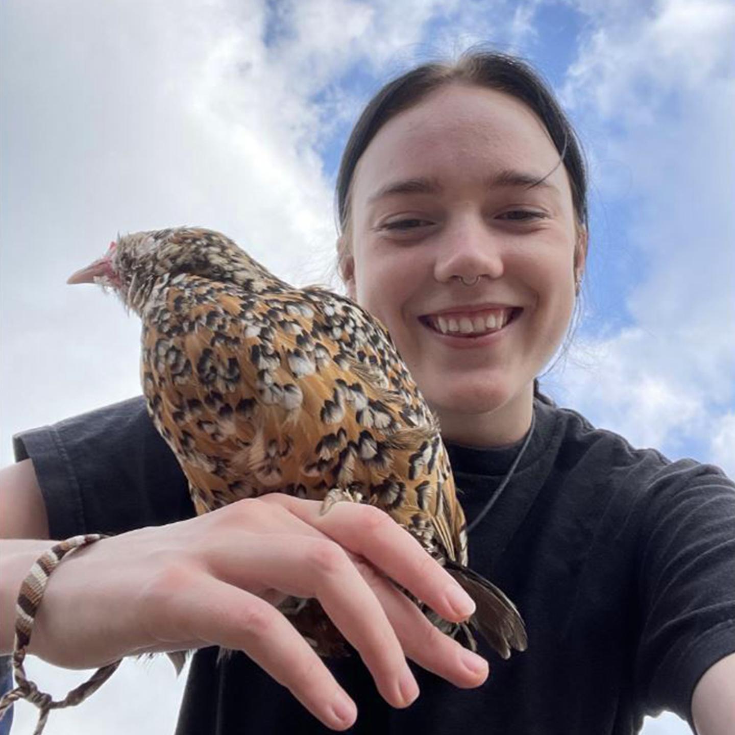 a woman holding a bird
