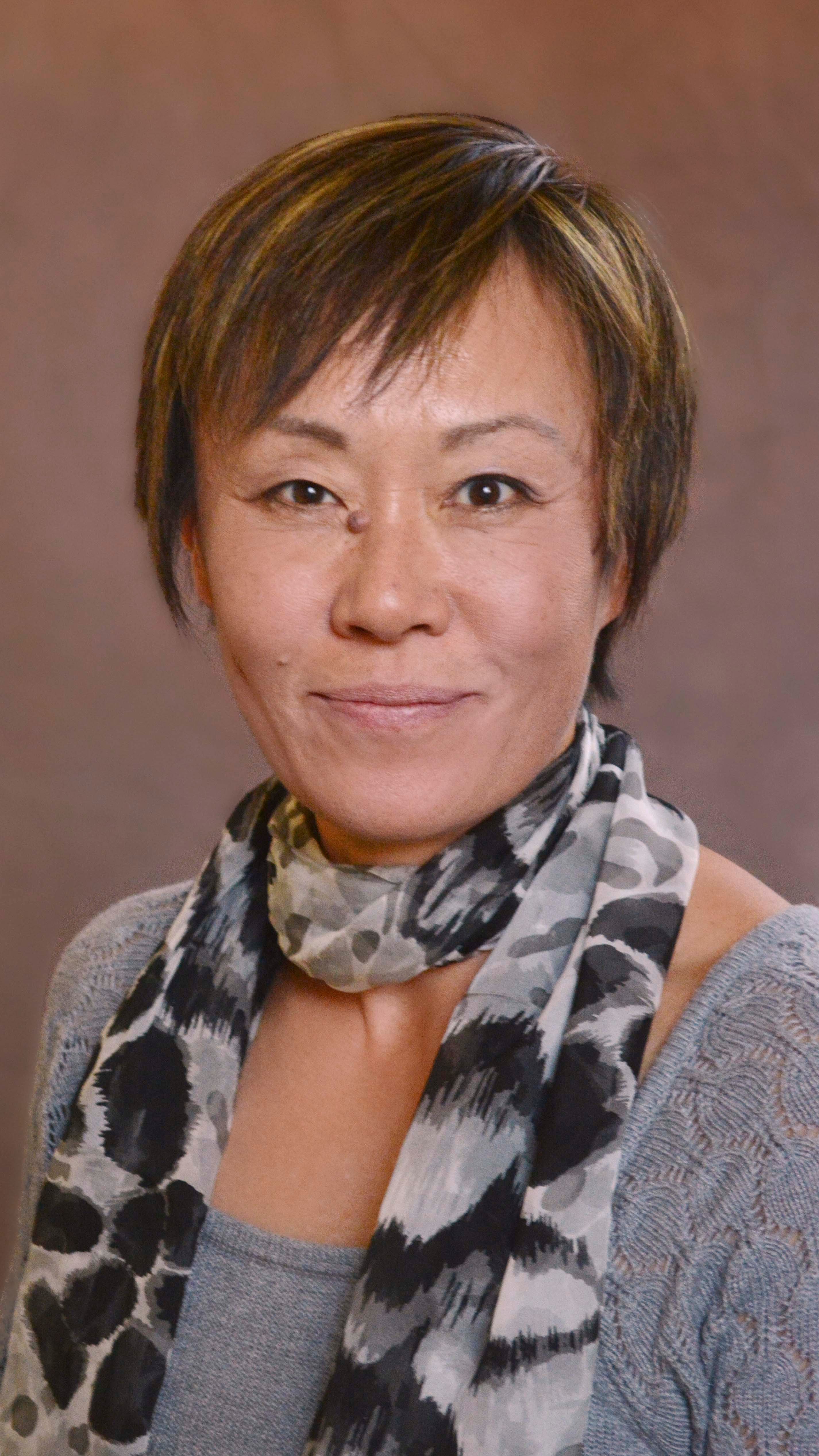 a woman with short hair wearing a scarf
