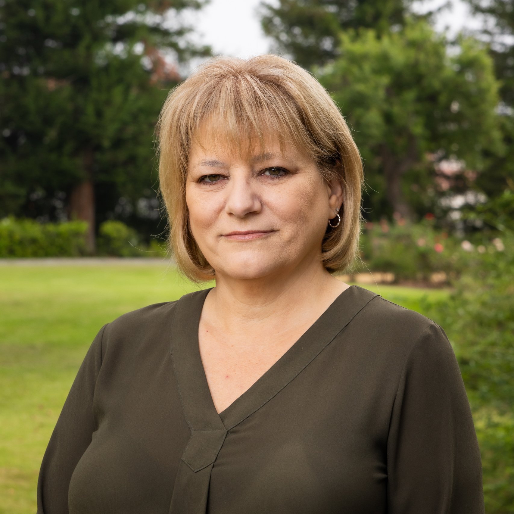 a woman standing in a grass field