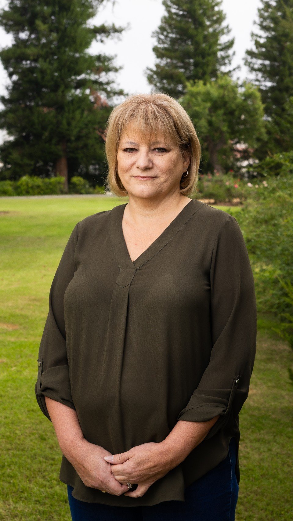 a woman standing in a grass field