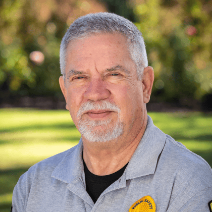 a man with a white beard and a gray shirt