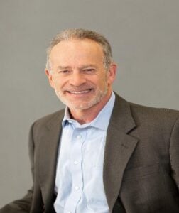 a man in a suit smiling