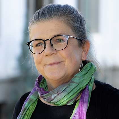 a woman wearing glasses and a scarf