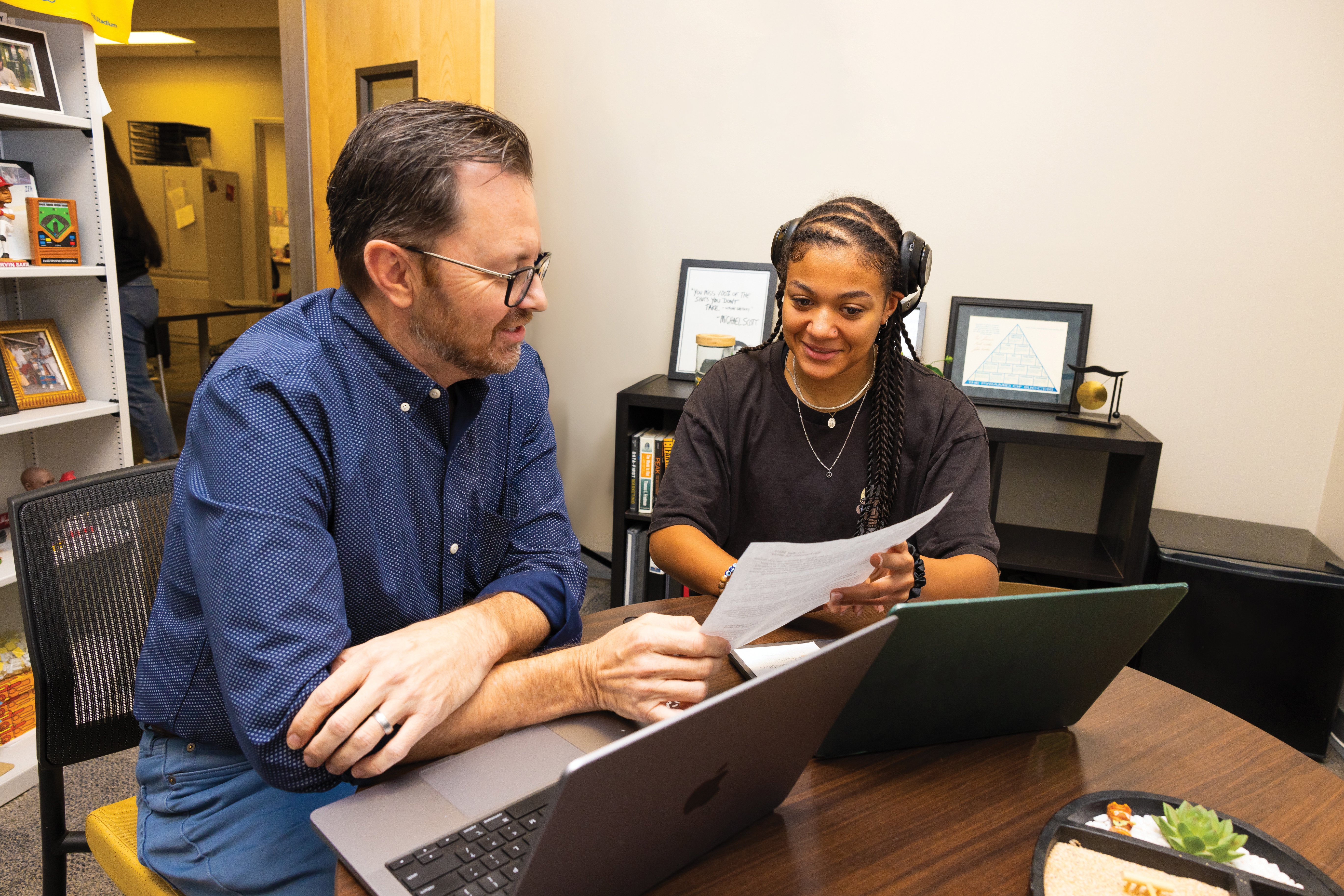 a man and woman looking at papers
